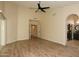Primary bedroom features wood-look flooring, an ensuite bathroom entrance, and an arched doorway at 1915 E Citation Ln, Tempe, AZ 85284