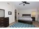 Comfortable bedroom features wood-look flooring, a ceiling fan, and ample closet space, creating a serene retreat at 1915 E Citation Ln, Tempe, AZ 85284