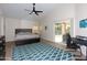 Cozy bedroom with wood-look flooring, ceiling fan, a desk area, and a sliding glass door to the patio at 1915 E Citation Ln, Tempe, AZ 85284