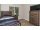 Bedroom with a stylish wooden bed and matching dresser next to a window at 1915 E Citation Ln, Tempe, AZ 85284
