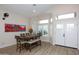 Bright dining room with a wooden table, bench seating, and hardwood floors at 1915 E Citation Ln, Tempe, AZ 85284