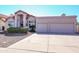 Inviting home exterior featuring a spacious driveway leading to a two-car garage and a meticulously kept front yard at 1915 E Citation Ln, Tempe, AZ 85284