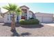 Charming single-story home with a well-manicured lawn, desert landscaping, and a vibrant red front door at 1915 E Citation Ln, Tempe, AZ 85284