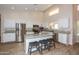 Bright kitchen features white cabinets, granite countertops, stainless steel appliances, and a center island with seating at 1915 E Citation Ln, Tempe, AZ 85284