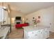 Open-concept living space with a stone fireplace, high ceilings, and wood-look flooring visible from the kitchen at 1915 E Citation Ln, Tempe, AZ 85284