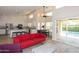 Open-concept living room with a kitchen view, features high ceilings, abundant natural light, and access to the outdoor pool at 1915 E Citation Ln, Tempe, AZ 85284