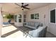 Relaxing covered patio featuring comfortable seating and a ceiling fan, perfect for outdoor living and entertaining at 1915 E Citation Ln, Tempe, AZ 85284