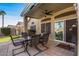 Back patio with seating, a ceiling fan, and a view of the grassy lawn at 19185 N 116Th Ln, Surprise, AZ 85378