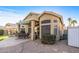 View of the rear of the home with outdoor seating, patio, and desert landscaping at 19185 N 116Th Ln, Surprise, AZ 85378