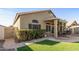 Image of the backyard with an artificial lawn, desert landscaping, and covered patio at 19185 N 116Th Ln, Surprise, AZ 85378