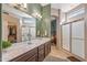 This light and airy bathroom features an extended vanity, and glass shower at 19185 N 116Th Ln, Surprise, AZ 85378