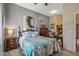Comfortable bedroom with a ceiling fan, en-suite bathroom, and decorative pillows at 19185 N 116Th Ln, Surprise, AZ 85378