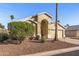 Charming single-story home with arched entryway, desert landscaping, and attached two car garage at 19185 N 116Th Ln, Surprise, AZ 85378