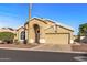 Charming single-story home with arched entryway, desert landscaping, and attached two car garage at 19185 N 116Th Ln, Surprise, AZ 85378
