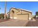 Charming single-story home with arched entryway, desert landscaping, and attached two car garage at 19185 N 116Th Ln, Surprise, AZ 85378