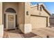 Inviting front door with decorative wreath, sidelights, and adjacent two-car garage at 19185 N 116Th Ln, Surprise, AZ 85378