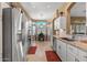 Bright and airy kitchen with stainless steel appliances, granite countertops, and a view of the dining area at 19185 N 116Th Ln, Surprise, AZ 85378