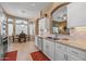 Well-lit kitchen with stainless steel appliances, white cabinets, granite countertops, and access to the dining area at 19185 N 116Th Ln, Surprise, AZ 85378