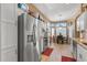 Spacious kitchen featuring stainless steel appliances, white cabinets, granite counters, and a breakfast nook at 19185 N 116Th Ln, Surprise, AZ 85378