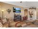 Inviting living room features a fireplace, mounted television, comfortable seating, and beautiful decorative details at 19185 N 116Th Ln, Surprise, AZ 85378