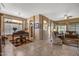Spacious living room featuring a grand piano, tiled floors, and ample natural light at 19185 N 116Th Ln, Surprise, AZ 85378