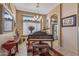 Charming living room with a grand piano and view to the kitchen at 19185 N 116Th Ln, Surprise, AZ 85378