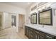 Bathroom featuring double sinks with contemporary fixtures and a large mirror at 20113 N Lagos Ct, Surprise, AZ 85374