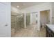 Bright bathroom features a glass shower with tile surround, large mirror, and toilet room at 20113 N Lagos Ct, Surprise, AZ 85374