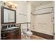 Bathroom featuring a tiled shower and vanity with a dark wood finish at 20113 N Lagos Ct, Surprise, AZ 85374