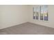 Bedroom featuring plush carpet flooring and ample natural light from the windows at 20113 N Lagos Ct, Surprise, AZ 85374