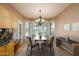 Inviting dining area with a modern chandelier and plenty of natural light at 20113 N Lagos Ct, Surprise, AZ 85374