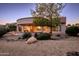 Exterior view of home features low maintenance desert landscape and covered patio at 20113 N Lagos Ct, Surprise, AZ 85374