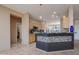 Open kitchen with tile floors, modern lighting, granite counters, and a unique bar design at 20113 N Lagos Ct, Surprise, AZ 85374