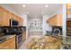 Bright kitchen with stainless steel appliances, custom cabinets, and granite countertops at 20113 N Lagos Ct, Surprise, AZ 85374