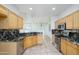 Updated kitchen with stainless steel appliances and granite countertops at 20113 N Lagos Ct, Surprise, AZ 85374