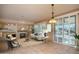 Cozy living room with fireplace, comfortable seating, and a modern light fixture at 20113 N Lagos Ct, Surprise, AZ 85374