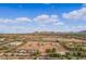 Wide aerial view showing ample equestrian facilities, storage and riding areas, and the surrounding area at 20386 E Bronco Dr, Queen Creek, AZ 85142