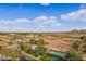 Beautiful aerial view showcasing the property's pool, mature trees, and the surrounding landscape at 20386 E Bronco Dr, Queen Creek, AZ 85142