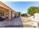 Relaxing backyard featuring a stone patio, lush lawn, and fireplace at 20386 E Bronco Dr, Queen Creek, AZ 85142