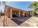 Serene backyard with stone patio, covered seating, and desert landscaping at 20386 E Bronco Dr, Queen Creek, AZ 85142