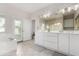 Bright bathroom featuring double sinks, large mirrors, tub and access to the exterior at 20386 E Bronco Dr, Queen Creek, AZ 85142