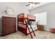 This bedroom has carpet, a ceiling fan and a bunk bed with a ladder at 20386 E Bronco Dr, Queen Creek, AZ 85142
