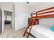 This bedroom features a ladder to the top bunk and a closet with sliding doors at 20386 E Bronco Dr, Queen Creek, AZ 85142