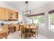 Bright dining area featuring a modern light fixture and a built in desk at 20386 E Bronco Dr, Queen Creek, AZ 85142
