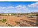 Wide aerial view showcasing vast equestrian facilities, including large riding arenas, stables, and open spaces at 20386 E Bronco Dr, Queen Creek, AZ 85142