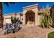 Charming home with desert landscaping, stone pavers, a decorative front door, and a covered entryway at 20386 E Bronco Dr, Queen Creek, AZ 85142