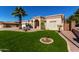 Lovely home with manicured lawn, desert plants, mature trees, and covered front entry at 20386 E Bronco Dr, Queen Creek, AZ 85142