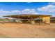 Spacious horse shelter with shaded area, stalls and a dirt lot, offering comfort and protection for animals at 20386 E Bronco Dr, Queen Creek, AZ 85142