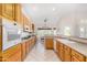 Bright kitchen with natural wood cabinetry and breakfast nook in view at 20386 E Bronco Dr, Queen Creek, AZ 85142