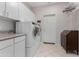 Functional laundry room equipped with white cabinets and modern washer and dryer at 20386 E Bronco Dr, Queen Creek, AZ 85142